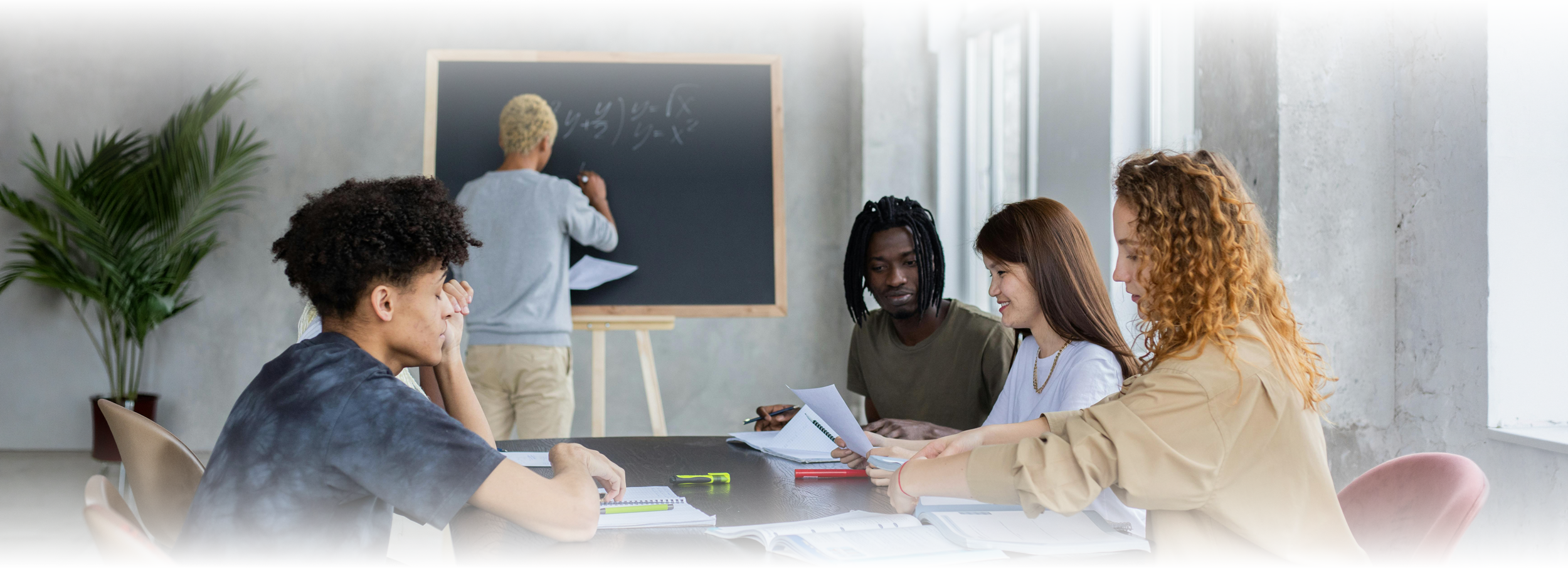 Group of people collaborating over work at a table